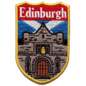 May include: An embroidered patch with a yellow border, depicting a castle with a red banner that reads "Edinburgh" and a blue and white Scottish flag.