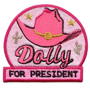 May include: Pink and white embroidered iron-on patch with a pink cowboy hat, two stars, and the text "Dolly for President".