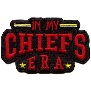 May include: Black and red embroidered patch with the text "In My Chiefs Era" with two yellow stars.
