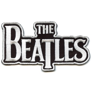 May include: Black and white embroidered patch with the text "THE BEATLES" in white lettering.