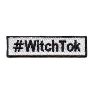 May include: A white rectangular embroidered patch with black stitching. The patch says "#WitchTok" in black.