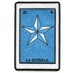 May include: A blue and white embroidered patch with a five-pointed star and the text "LA ESTRELLA" and the number "35" in a white frame.