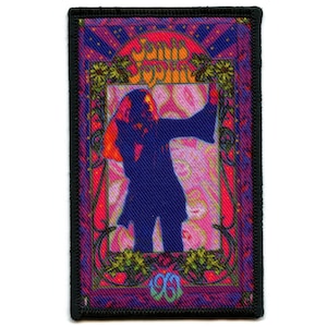May include: A colorful embroidered patch featuring a silhouette of Janis Joplin singing in a psychedelic frame with the text "Janis Joplin" and "1968".