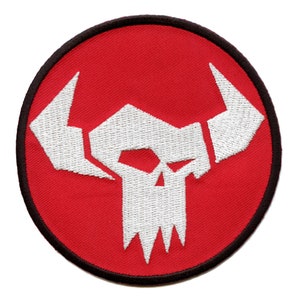 May include: White embroidered skull with horns on a red circular patch with a black border.