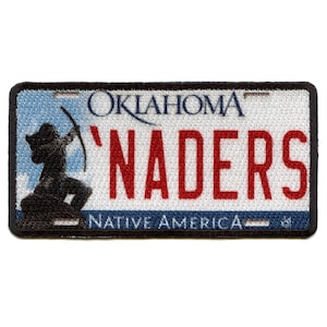 May include: A white and blue Oklahoma license plate with the text "'Naders" in red and the words "Native America" at the bottom. The plate features a silhouette of a Native American archer.