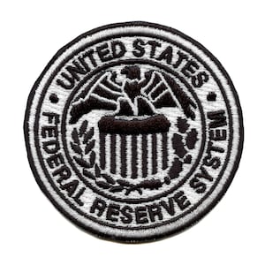 May include: A black and white embroidered patch with the words "United States Federal Reserve System" in a circle.
