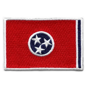 May include: Embroidered patch of the Tennessee state flag. The flag is red with a blue circle containing three white stars in the centre. The patch has a white border.
