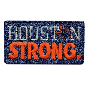 May include: An embroidered patch in blue and orange with the text "HOUSTON STRONG" and a small outline of the state of Texas.