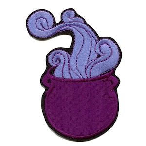 May include: Purple cauldron with a swirling purple smoke coming out of the top. The cauldron is embroidered with black stitching.