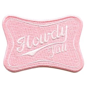 Puede incluir: Parche de tela rosa con texto bordado en blanco que dice "Howdy Y'all".