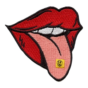 May include: Embroidered patch of red lips with a pink tongue. The tongue displays a small yellow square with a smiling face. The lips have white teeth and black outlines, creating a bold design.