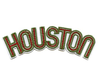 May include: Embroidered patch with the word "HOUSTON" in a stylised font, featuring green and red stitching.