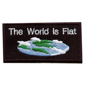 May include: Embroidered patch with the text "The World Is Flat" in white on a dark brown rectangular background. The patch features a stylized image of the Earth with green land, blue water, and white clouds.