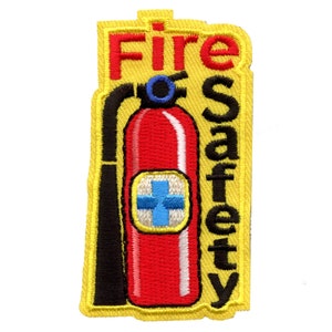 May include: Yellow embroidered patch with the words "Fire Safety" and a red fire extinguisher with a blue cross on it.