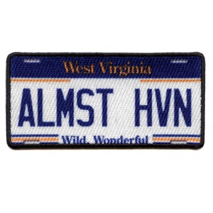 May include: A blue and white West Virginia license plate patch with the text "ALMST HVN" and the words "Wild. Wonderful." at the bottom.
