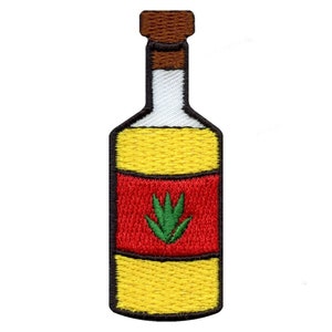 Può includere: Una bottiglia gialla con un'etichetta rossa e un disegno di pianta di agave verde. La bottiglia ha un tappo di sughero marrone.