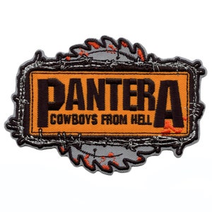 May include: An orange and black embroidered patch with the word "PANTERA" and the text "COWBOYS FROM HELL" inside a barbed wire frame.