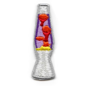 May include: A silver-colored lava lamp with a purple base and orange, red, and yellow lava. The lava lamp is a popular retro home decor item.