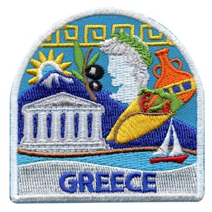 May include: Embroidered patch with a blue background featuring a white building, a yellow sun, a green olive branch, a white cloud, a yellow and orange vase, and a red sailboat. The text "GREECE" is written in blue at the bottom of the patch.