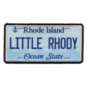 Może przedstawiać: Naszywka haftowana w kolorze niebieskim i białym z tekstem "Rhode Island", "Little Rhody" i "Ocean State".