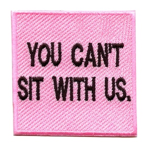 May include: Pink fabric patch with black embroidered text that reads "YOU CAN'T SIT WITH US."