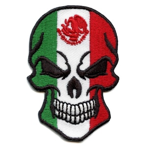 May include: Embroidered patch of a white skull with a green, white and red Mexican flag design. The skull has black eyes and a toothy grin.
