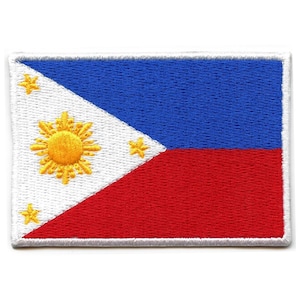 May include: An embroidered patch of the Philippine flag. The flag is white with a blue triangle at the hoist and a red rectangle at the fly. The triangle features a yellow sun with eight rays and three five-pointed stars.