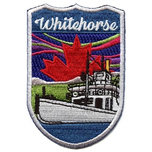 May include: Whitehorse, Yukon Territory, Canada embroidered patch with a red maple leaf, a white ship, and a blue, green, and purple aurora borealis design.