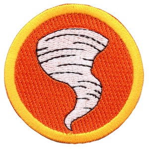 May include: A round, orange and yellow embroidered patch with a white tornado design.