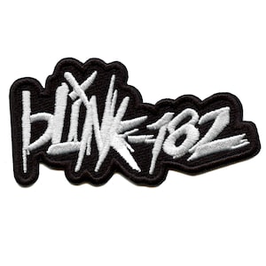 May include: Black and white embroidered patch with the text "blink-182" in a stylized font.
