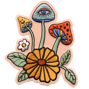 May include: Embroidered patch featuring a whimsical design of mushrooms and a flower. The mushrooms have colorful caps with details like eyes and polka dots. The flower is yellow with a brown center and green leaves.