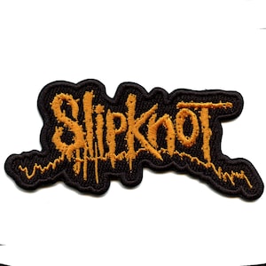 May include: Black and gold embroidered patch with the word "Slipknot" in a stylised font.