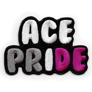 Op de afbeelding: Zwarte en witte geborduurde patch met de tekst "ACE PRIDE" in witte en grijze letters. De tekst "PRIDE" is in grijs, wit en roze, wat de asexuele pride-vlag voorstelt.