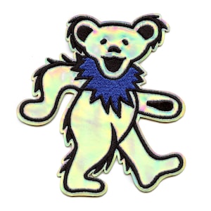 May include: A holographic bear patch with a blue collar and black outline. The bear is smiling and has its arms and legs outstretched. The patch is on a white background.