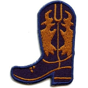 May include: An embroidered iron-on patch of a purple cowboy boot with gold stitching. The boot has a pointed toe and a tall shaft. The stitching on the boot is in the shape of a stylized flame.