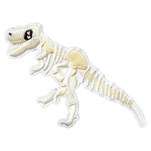 May include: White embroidered iron-on patch of a dinosaur skeleton. The dinosaur is standing on its hind legs with its tail outstretched.
