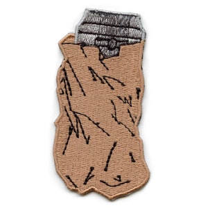 May include: A brown embroidered patch of a lighter with a silver top. The lighter has a textured design.