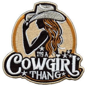 May include: Embroidered patch with a silhouette of a woman wearing a cowboy hat. The text reads "It's a Cowgirl Thang" with stars around the text.