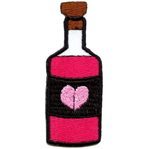 May include: A pink glass bottle with a brown cork top and a black label with a pink heart on it.