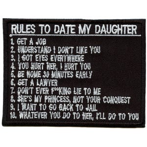 May include: Black rectangular patch with white embroidered text. The patch reads "RULES TO DATE MY DAUGHTER" followed by ten rules, including "GET A JOB" and "YOU HURT HER, I HURT YOU."