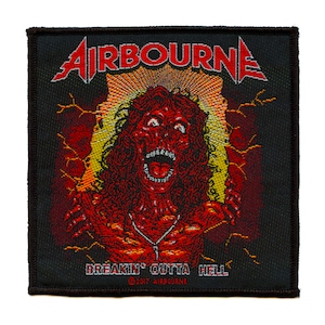 May include: A black woven patch with the band name "AIRBOURNE" in red and yellow lettering. The patch features a red and yellow illustration of a screaming demon with a chain necklace. The text "BREAKIN' OUTTA HELL" is below the illustration with the copyright symbol and "2017 AIRBOURNE".