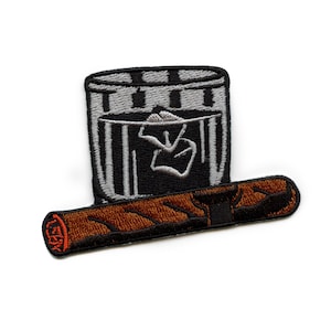 May include: Embroidered iron-on patch featuring a black and white trash can with a white cigarette inside and a brown and black cigar on the bottom.