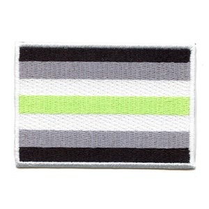 May include: A green, white, grey, and black striped flag patch. The patch is embroidered and has a white border.