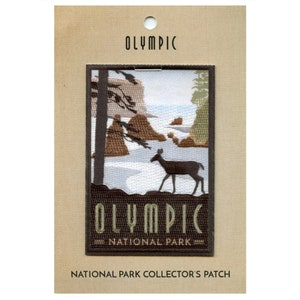 May include: Embroidered patch depicting a scenic view of Olympic National Park with a deer in the foreground. The patch is brown with green and white accents and reads "Olympic National Park".