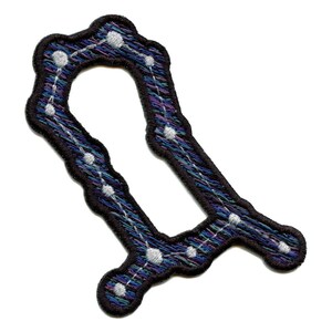May include: A black embroidered patch featuring a constellation design in shades of blue, purple, and white. The constellation is shaped like the letter "U".