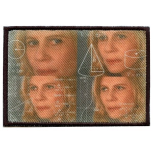 May include: A brown fabric patch featuring a collage of four images of a woman's face. The images are arranged in a grid pattern and overlaid with white geometric shapes and mathematical equations.