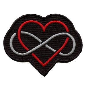 Puede incluir: Parche bordado negro con un corazón rojo y un símbolo de infinito plateado entrelazados. El corazón y el símbolo de infinito están cosidos juntos para formar un solo diseño.
