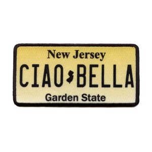 May include: A yellow and black New Jersey license plate patch with the text "CIAO BELLA" and the words "New Jersey" and "Garden State" above and below the text.