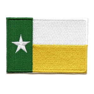 Può includere: Una toppa ricamata con la bandiera dello stato del Texas. La bandiera è verde, bianca e dorata con una singola stella bianca nella sezione verde.