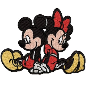 May include: An embroidered patch featuring Mickey Mouse and Minnie Mouse sitting side-by-side. Mickey is wearing red shorts and yellow shoes, while Minnie is wearing a red dress with a yellow bow and yellow shoes.